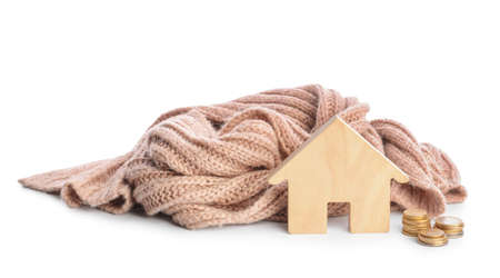 Figure of house and warm scarf on white background. Concept of heating seasonの写真素材