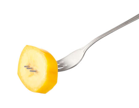 Fork with piece of banana on white backgroundの写真素材