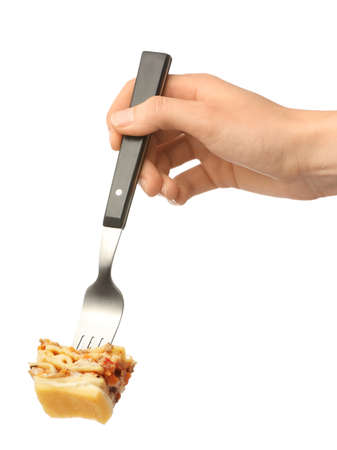 Female hand and fork with lasagna on white backgroundの写真素材