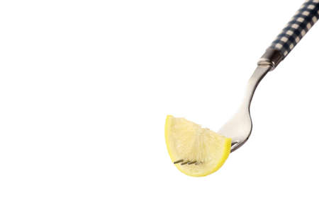 Fork with lemon slice on white backgroundの写真素材