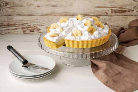 Dessert stand with tasty banana pie on tableの写真素材