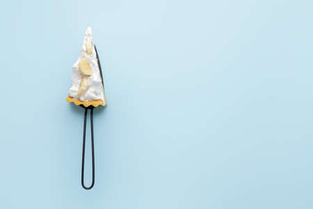 Spatula with piece of tasty banana pie on color backgroundの写真素材