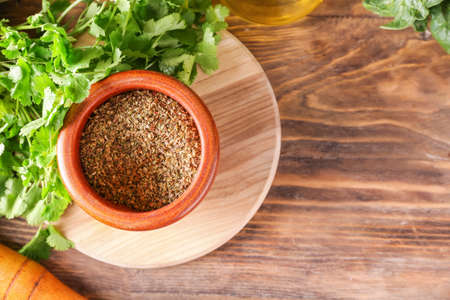 Mortar with spices and pestle on wooden backgroundの写真素材