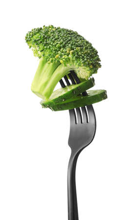 Fork with broccoli and cucumber on white backgroundの写真素材
