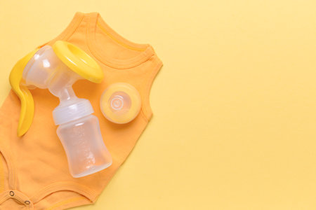 Breast pump and baby accessories on color backgroundの写真素材
