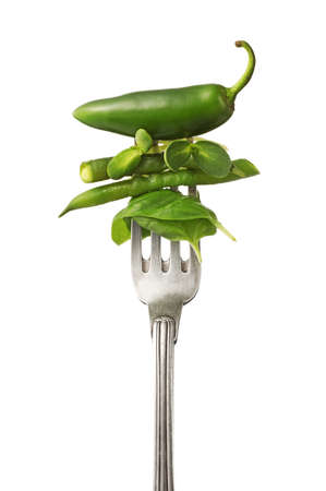 Fork with pepper and herbs on white backgroundの写真素材