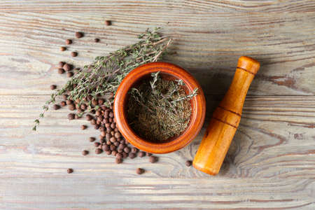 Mortar with spices and pestle on wooden backgroundの写真素材