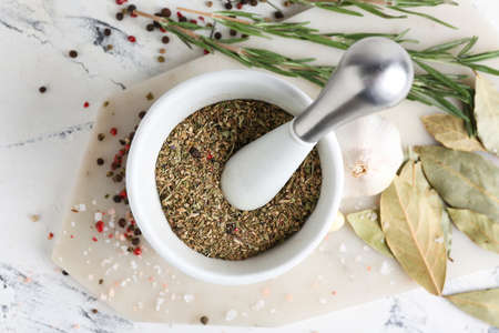 Mortar with spices and pestle on light backgroundの写真素材