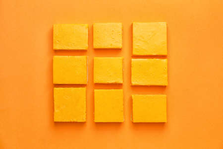 Pieces of tasty pumpkin pie on color backgroundの写真素材