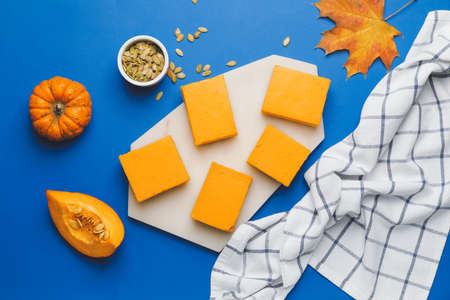 Pieces of tasty pumpkin pie on color backgroundの写真素材