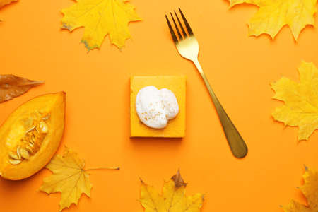 Autumn composition with piece of tasty pumpkin pie on color backgroundの写真素材