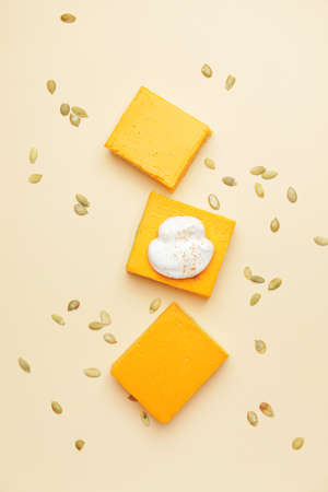 Pieces of tasty pumpkin pie on color backgroundの写真素材