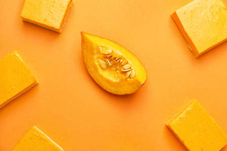 Pieces of tasty pumpkin pie on color backgroundの写真素材