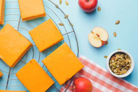 Pieces of tasty pumpkin pie on color backgroundの写真素材