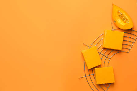 Pieces of tasty pumpkin pie on color backgroundの写真素材
