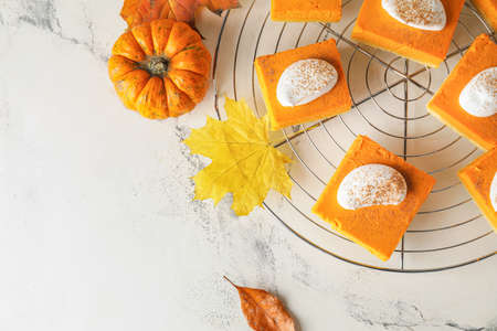 Pieces of tasty pumpkin pie on tableの写真素材