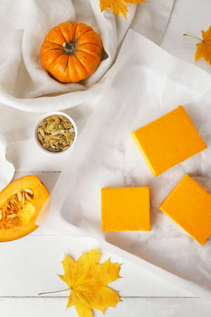 Tray with pieces of tasty pumpkin pie on tableの写真素材