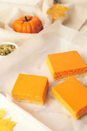 Tray with pieces of tasty pumpkin pie on tableの写真素材