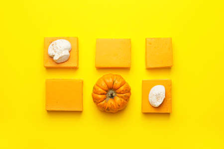 Pieces of tasty pumpkin pie on color backgroundの写真素材