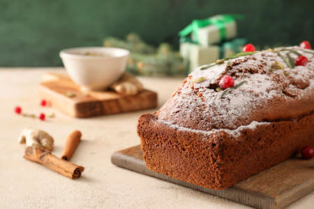 Board with tasty gingerbread cake on light backgroundの写真素材