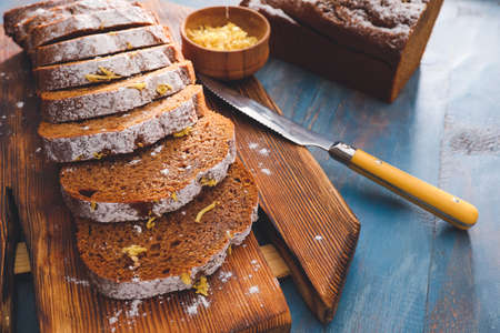Board with tasty gingerbread cake on color wooden backgroundの写真素材