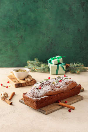 Board with tasty gingerbread cake on tableの写真素材