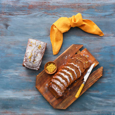 Board with tasty gingerbread cake on color wooden backgroundの写真素材