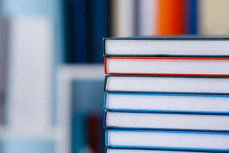 Stack of books on table in libraryの写真素材