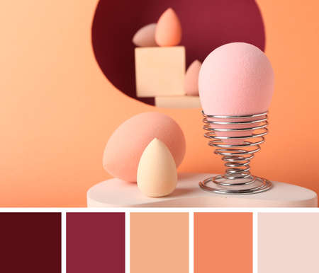 Makeup sponges on orange background. Different color patternsの写真素材