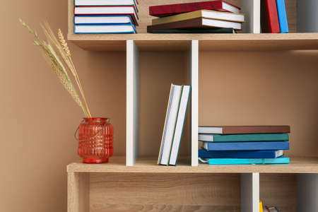 Shelf unit with books on color backgroundの写真素材