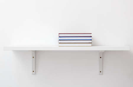 Shelf with books on light backgroundの写真素材