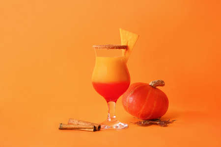 Glass of tasty pumpkin pie martini on color backgroundの写真素材