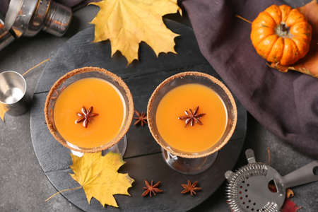 Glasses of tasty pumpkin pie martini on dark backgroundの写真素材
