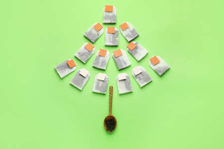 Christmas tree shape made of tea bags on color backgroundの写真素材