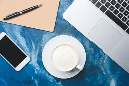 Cup of tasty latte on color backgroundの写真素材