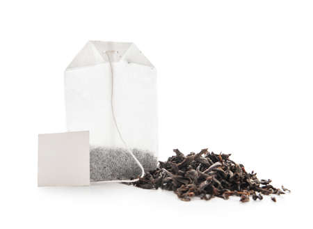 Tea bag and dry leaves on white backgroundの写真素材