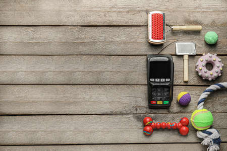 Payment terminal with pet care accessories on wooden backgroundの写真素材