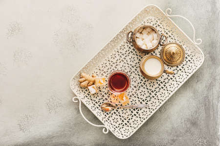 Glass of tasty Turkish tea and delights on light backgroundの写真素材