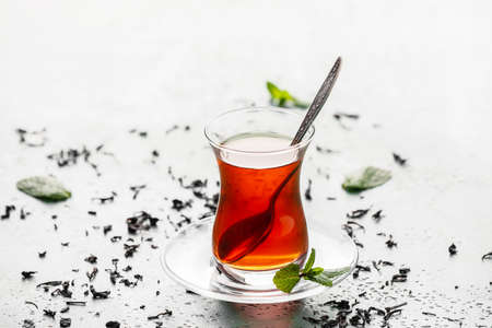 Glass of tasty Turkish tea on light backgroundの写真素材