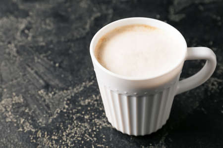 Cup of tasty latte on dark backgroundの写真素材