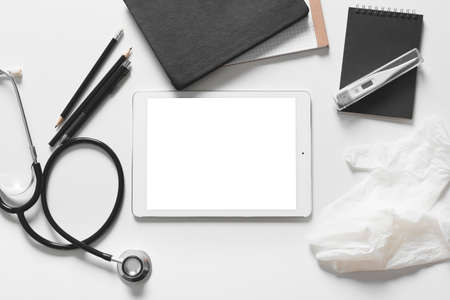 Composition with modern stethoscope and tablet computer on light backgroundの写真素材