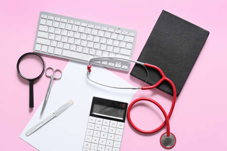 Composition with modern stethoscope and computer keyboard on color backgroundの写真素材