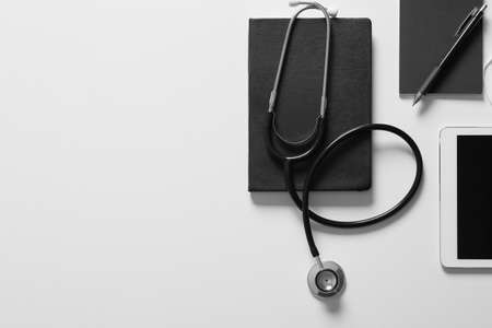 Composition with modern stethoscope and tablet computer on light backgroundの写真素材