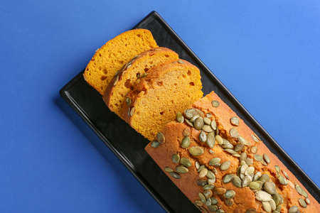 Tasty pumpkin pie on color background