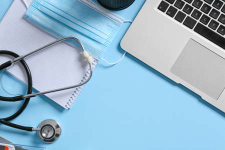 Composition with modern stethoscope and laptop on color backgroundの写真素材