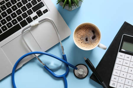Composition with modern stethoscope and laptop on color backgroundの写真素材