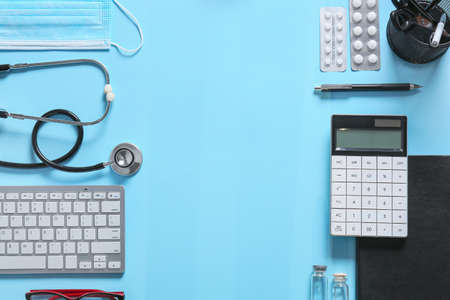 Composition with modern stethoscope and computer keyboard on color backgroundの写真素材