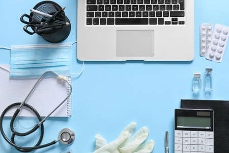 Composition with modern stethoscope and laptop on color backgroundの写真素材