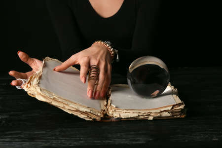 Fortune teller reading future at table