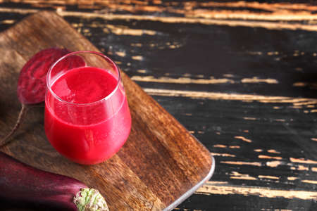 Glass of healthy smoothie with vegetables on dark wooden backgroundの写真素材